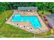 Relaxing community pool area with plenty of seating and umbrellas, perfect for summer days at 1216 Miracle Dr, Wake Forest, NC 27587