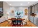 Elegant dining area with a wooden table, wainscoting, hardwood floors, and a large window at 1216 Miracle Dr, Wake Forest, NC 27587