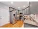 Modern kitchen featuring stainless steel appliances, granite countertops, and gray cabinetry at 1216 Miracle Dr, Wake Forest, NC 27587