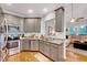 Bright kitchen features stainless steel appliances, granite countertops, and gray cabinetry at 1216 Miracle Dr, Wake Forest, NC 27587