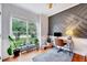 Bright office boasts an accent wall, hardwood floors and a large window for natural light at 1216 Miracle Dr, Wake Forest, NC 27587