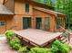 Stunning wood exterior with an expansive back deck perfect for entertaining, with lush landscaping at 122 Blackcherry Ln, Chapel Hill, NC 27514