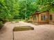 Picturesque backyard with brick patio and lush greenery, perfect for outdoor relaxation at 122 Blackcherry Ln, Chapel Hill, NC 27514