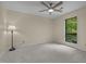 Simple bedroom with neutral walls, carpeted floors, and a large window that provides outdoor views at 122 Blackcherry Ln, Chapel Hill, NC 27514
