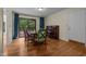 Dining room features hardwood floors, a piano, and sliding glass doors to an outdoor deck at 122 Blackcherry Ln, Chapel Hill, NC 27514