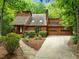 Charming home featuring a two-car garage, manicured front yard, and inviting stone walkway at 122 Blackcherry Ln, Chapel Hill, NC 27514
