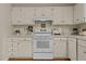 Traditional-style kitchen with bright white cabinets, modern appliances, and plenty of counter space at 122 Blackcherry Ln, Chapel Hill, NC 27514