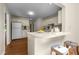 Bright kitchen with an island, stainless steel appliances, and a view of an adjacent living area at 122 Blackcherry Ln, Chapel Hill, NC 27514