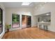 Open concept living area with hardwood floors, sliding glass doors to a deck, and a kitchen view at 122 Blackcherry Ln, Chapel Hill, NC 27514