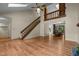 Large living room with hardwood floors, a fireplace, skylights, and an open staircase at 122 Blackcherry Ln, Chapel Hill, NC 27514