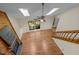 Aerial view of a bright living room featuring a fireplace, hardwood floors, and skylights at 122 Blackcherry Ln, Chapel Hill, NC 27514