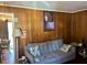 Cozy living room featuring paneled walls, a comfortable couch, and natural light at 1310 Ray Ave, Sanford, NC 27330