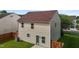 Backyard view of a home with vinyl siding, fenced yard, and a small patio at 1310 Silver Dr, Mebane, NC 27302