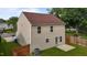 View of the backyard featuring a well-maintained lawn, privacy fence, and the home's exterior at 1310 Silver Dr, Mebane, NC 27302