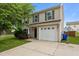 Charming two-story home featuring neutral siding, green shutters, a one-car garage and a well-manicured lawn at 1310 Silver Dr, Mebane, NC 27302