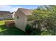 Side view of a charming two-story home with vinyl siding, fenced yard, and lush landscaping at 1310 Silver Dr, Mebane, NC 27302