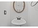 Charming half bathroom featuring a pedestal sink and decorative mirror at 1310 Silver Dr, Mebane, NC 27302