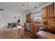 Bright kitchen with wood cabinets, a window over the sink, and an adjacent dining area with a chandelier at 1310 Silver Dr, Mebane, NC 27302
