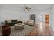 Bright living room with neutral walls, modern furniture, a ceiling fan, and hardwood flooring at 1310 Silver Dr, Mebane, NC 27302