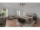 Spacious main bedroom featuring a tray ceiling, sitting area, and laminate flooring at 1310 Silver Dr, Mebane, NC 27302