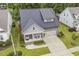 Aerial view of the home showcasing landscaping, an attached two car garage and a well maintained lawn at 1374 Patriot Points Way, Fuquay Varina, NC 27526