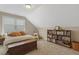 Attic bedroom with natural light and a built-in bookshelf at 1374 Patriot Points Way, Fuquay Varina, NC 27526