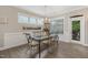 Dining room with decorative table, chandelier, lots of natural light, and door to back porch at 1374 Patriot Points Way, Fuquay Varina, NC 27526