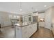 Open kitchen layout with island seating, stainless steel appliances, and an adjacent dining area at 1374 Patriot Points Way, Fuquay Varina, NC 27526