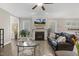 Spacious living room features a fireplace, ceiling fan, and comfortable leather sofa at 1374 Patriot Points Way, Fuquay Varina, NC 27526