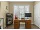 Home office with wood desk, bookshelves, and plenty of natural light from the large window at 1374 Patriot Points Way, Fuquay Varina, NC 27526
