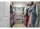 Organized walk-in closet with shelving and hanging space for clothes and accessories at 1374 Patriot Points Way, Fuquay Varina, NC 27526