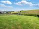 Spacious backyard with green grass, playground, and a black metal fence at 146 Bent Willow Dr, Clayton, NC 27527