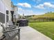 Spacious backyard featuring a well-maintained lawn, black fence, playground set and patio seating at 146 Bent Willow Dr, Clayton, NC 27527