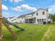 Large backyard with a screened-in porch, patio furniture, and a slide at 146 Bent Willow Dr, Clayton, NC 27527