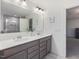 Modern bathroom featuring double vanity, quartz countertop, and a large mirror at 146 Bent Willow Dr, Clayton, NC 27527