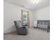 Comfortable Bedroom features a gray rocking chair, crib, and window at 146 Bent Willow Dr, Clayton, NC 27527