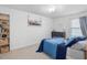 Bedroom features a twin bed with blue bedding, dresser and bookcase at 146 Bent Willow Dr, Clayton, NC 27527