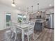 Dining area with kitchen in the background, features grey wood cabinets and floors at 146 Bent Willow Dr, Clayton, NC 27527
