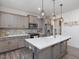 Kitchen with large island, stainless steel appliances, and modern pendant lighting at 146 Bent Willow Dr, Clayton, NC 27527