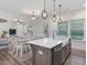 Kitchen island with sink, and dining table next to living room at 146 Bent Willow Dr, Clayton, NC 27527