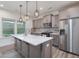Open kitchen with stainless steel appliances, large island, and stylish pendant lighting at 146 Bent Willow Dr, Clayton, NC 27527