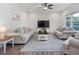 Bright living room with neutral colors, hardwood floors, and a cozy seating area at 146 Bent Willow Dr, Clayton, NC 27527