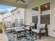 Relaxing covered patio with seating area, ceiling fan, and view of the backyard at 146 Bent Willow Dr, Clayton, NC 27527