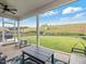 Screened porch with outdoor seating and a view of the large, fenced backyard with playground equipment at 146 Bent Willow Dr, Clayton, NC 27527