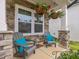 Relaxing front porch with comfortable seating and decorative hanging baskets at 146 Bent Willow Dr, Clayton, NC 27527