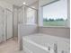 Modern bathroom showcasing a large walk-in shower and luxurious soaking tub at 146 Bent Willow Dr, Clayton, NC 27527