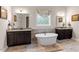 Modern bathroom with a freestanding tub, double vanity, and neutral finishes at 1508 Banks Brooke Dr, Raleigh, NC 27603