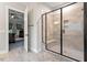 Modern bathroom featuring a tiled shower with a glass door and a glimpse of the bedroom through the doorway at 1508 Banks Brooke Dr, Raleigh, NC 27603