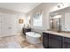 Modern bathroom with a freestanding tub, double vanity, and large walk in shower at 1508 Banks Brooke Dr, Raleigh, NC 27603