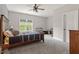 Spacious bedroom showcasing a comfortable bed with a blue patterned comforter, a ceiling fan, and a bright window at 1508 Banks Brooke Dr, Raleigh, NC 27603